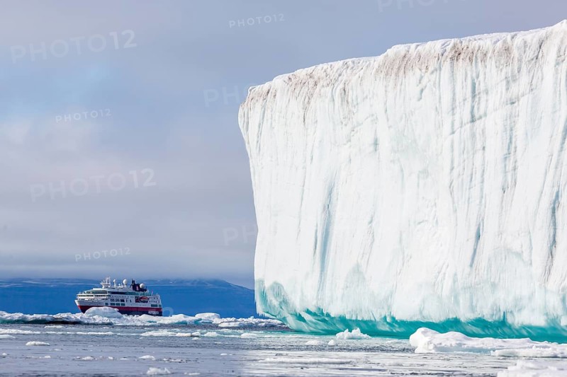 Cruise ship behind iceberg