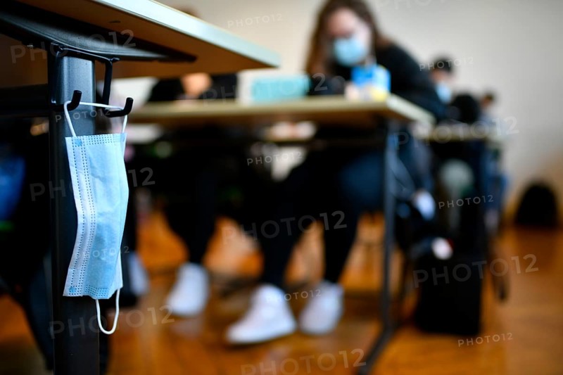 Face mask hangs on school desk