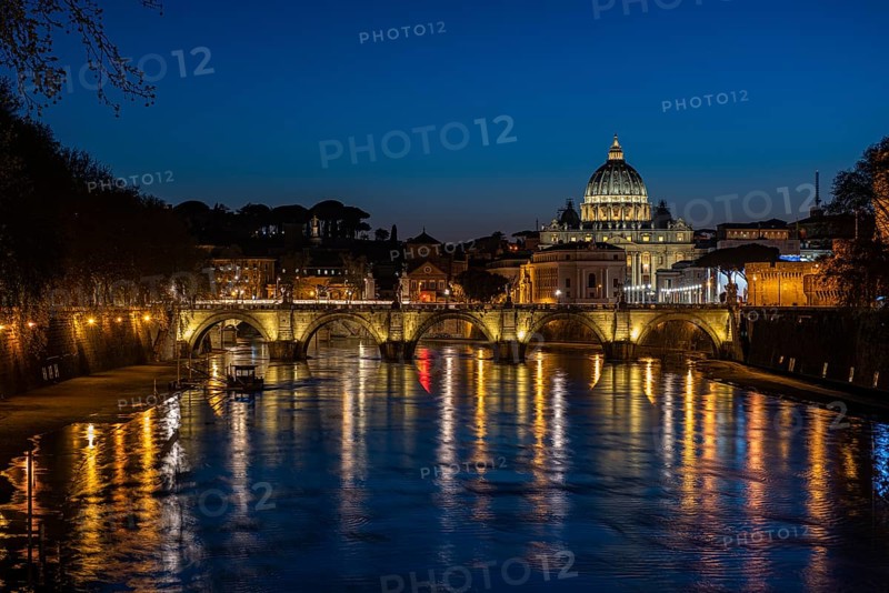 View over the Tiber at evening light on Ponte Sant`Angelo and St. Peter's Basilica
