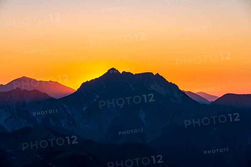 Sunset behind mountain silhouette