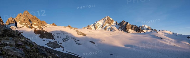 Hiker photographs mountain panorama