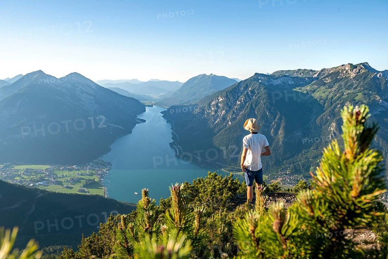 Young man looking over mountain landscape