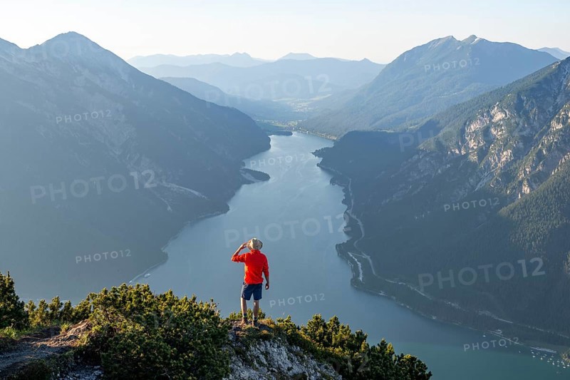 Young man looking over mountain landscape