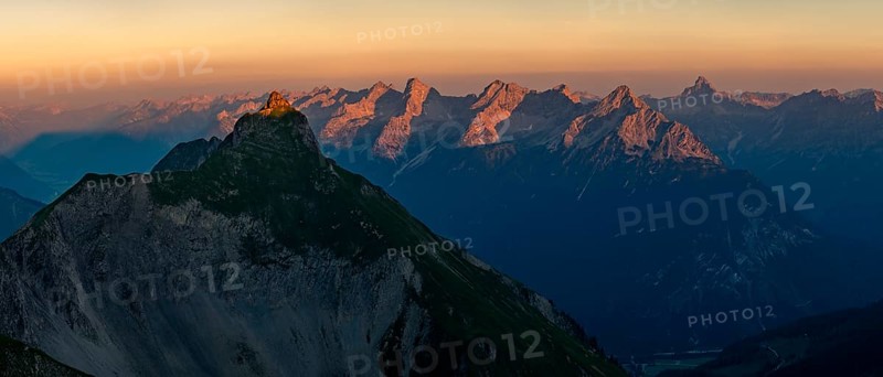 Summit of the Pfeilspitze in the foreground and Hornbachkette in the background at sunrise