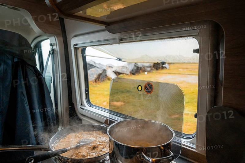 Spaghetti with creamy cream sauce cooked on gas stove in Campervan