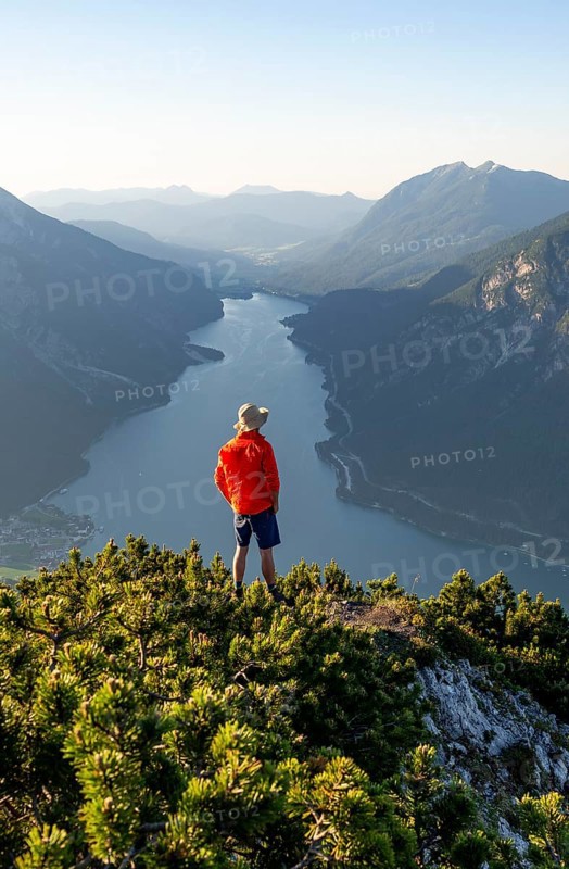 Young man looking over mountain landscape