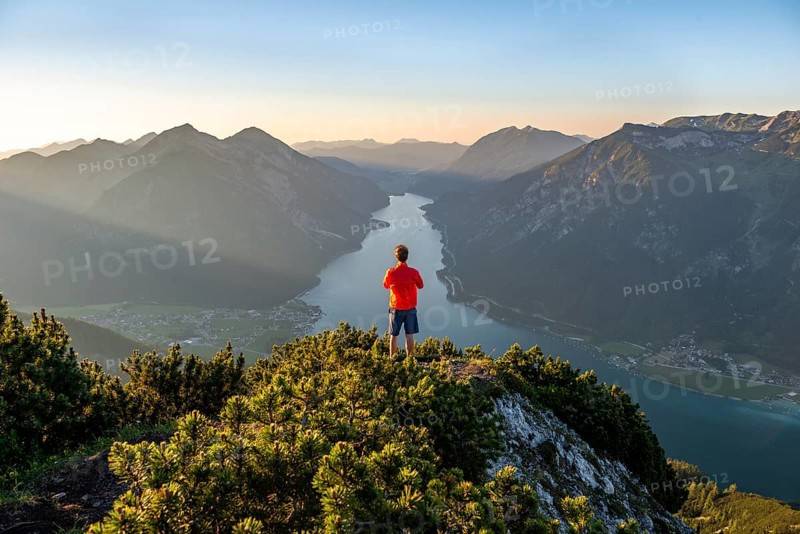 Young man looking over mountain landscape