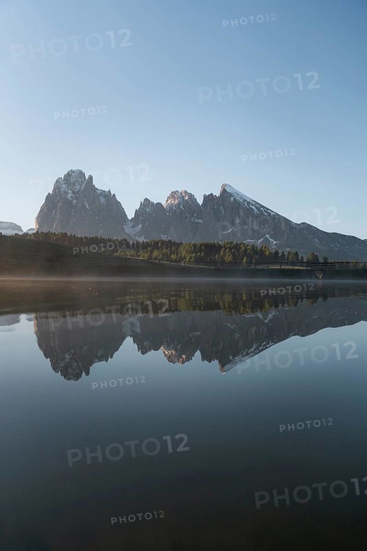 Sassolungo and Plattkofel are reflected in the small lake