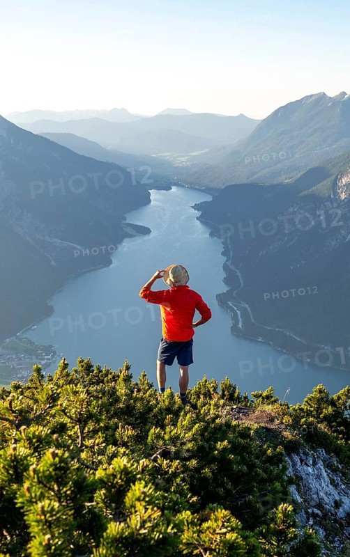 Young man looking over mountain landscape