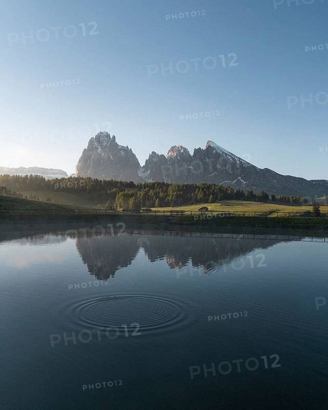 Sassolungo and Plattkofel are reflected in the small lake