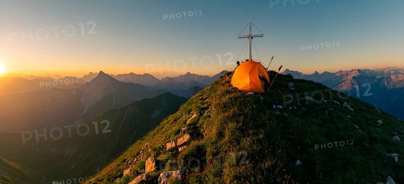 Cross of the Kreuzspitze with tent at the summit