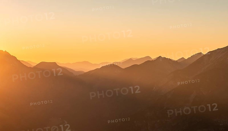 Sunset behind mountain silhouette