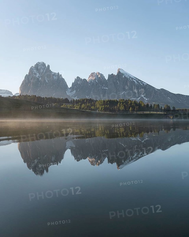Sassolungo and Plattkofel are reflected in the small lake