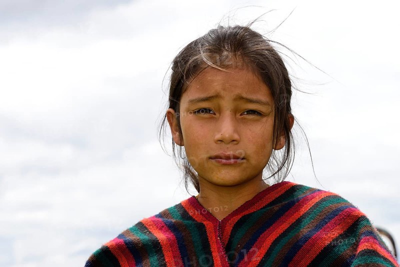 Indigenous girl looks seriously into the camera