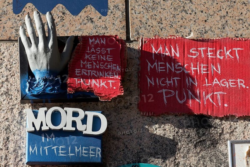 Outstretched hand and writing Murder in the Mediterranean Sea