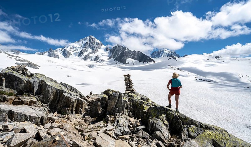 Hiker standing in front of glacier