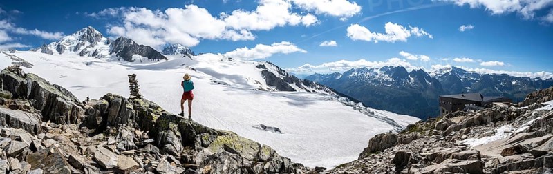 Hiker standing in front of glacier