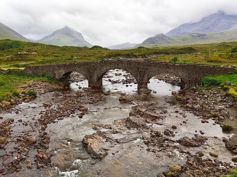 Old stone bridge Sligachan Bridge in front of Cuillin Hills mountains