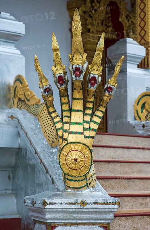 Five-headed mythological Naga serpent decorates the end of a stair railing