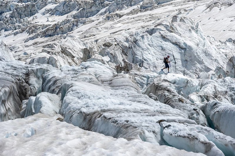 Climber walking on rutted glacier