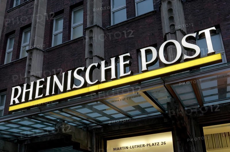 Illuminated logo of the daily newspaper Rheinische Post on the former editorial building Martin-Luther-Platz