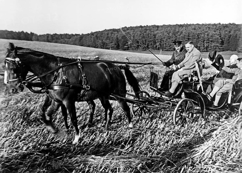 Paul von Hindenburg riding in a carriage across a stubble field inspecting his lands