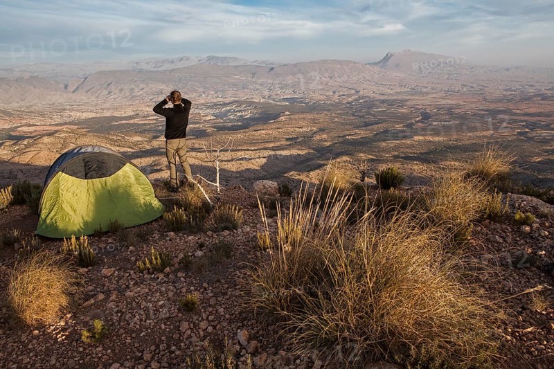 Young man contemplates the landscape of the Jbel Bou Naceur mountain in the province of Sefru
