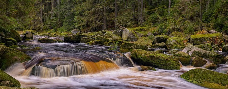 Waterfall at the Vydra with huge boulders in the riverbed
