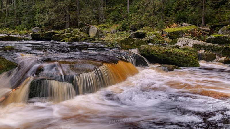 Waterfall at the Vydra with huge boulders in the riverbed