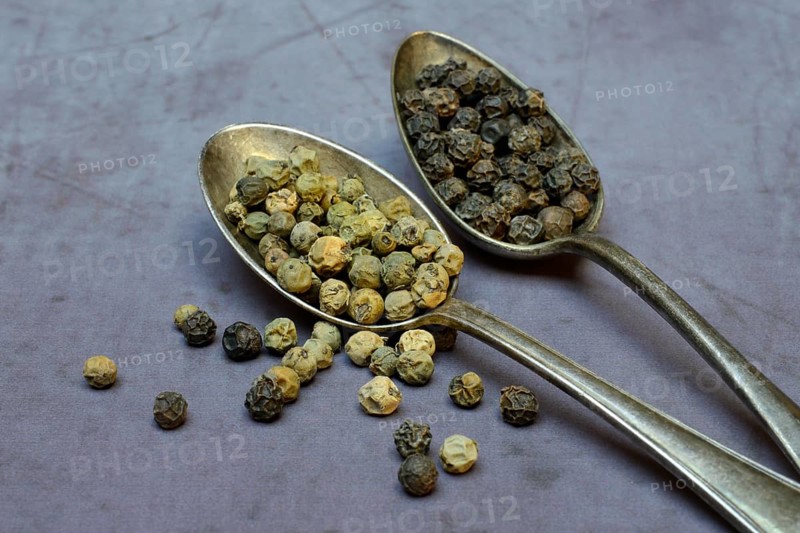 Peppercorns in spoon