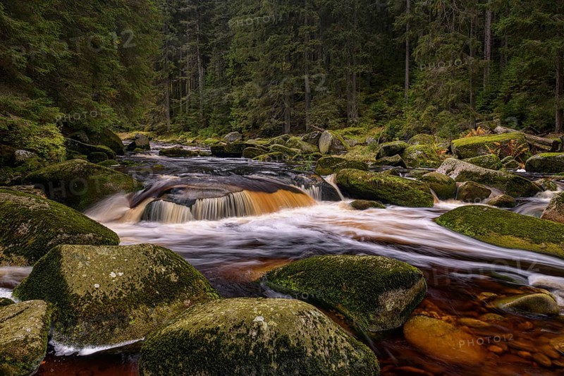 Waterfall at the Vydra with huge boulders in the riverbed