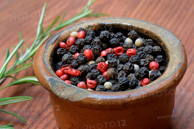 Black and white peppercorns in pot