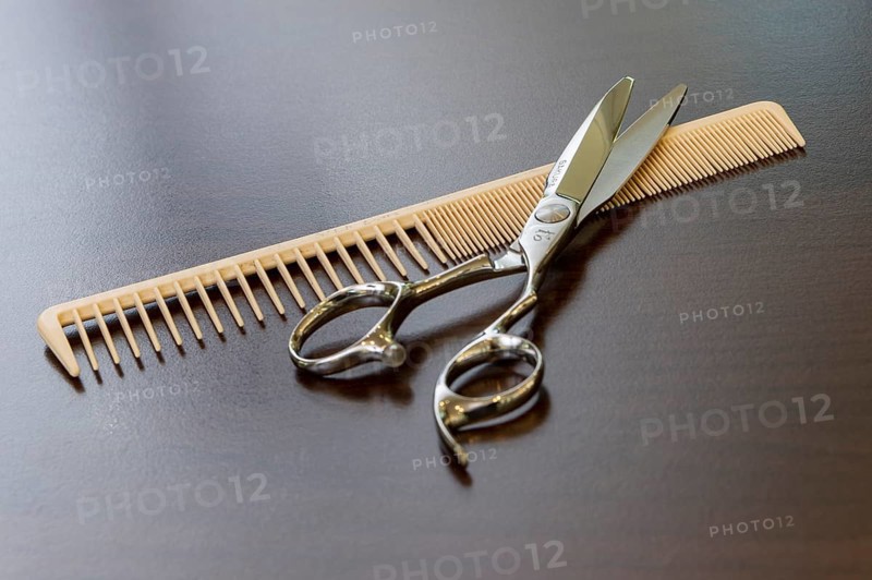 Scissors and comb lie on a table