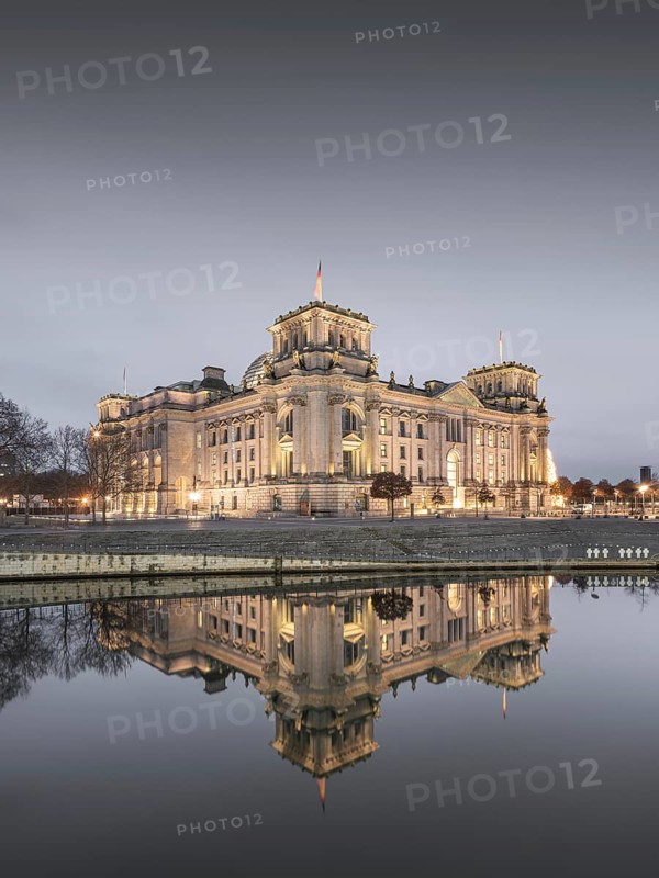 Reichstag with waving German flag at the Spree