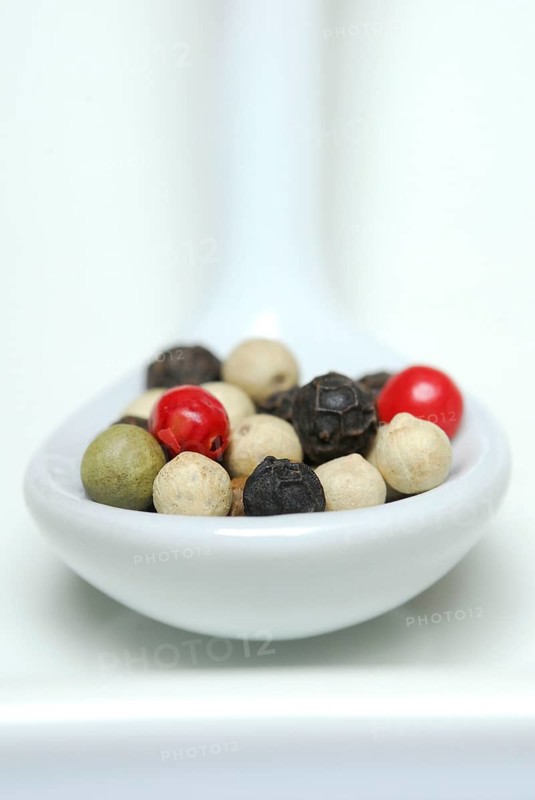 Peppercorns in porcelain spoon