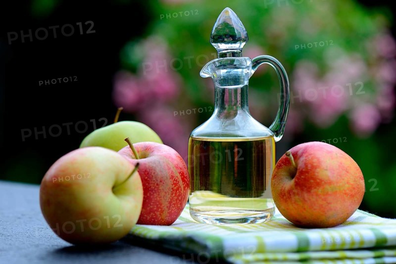 Carafe with apple vinegar and apples