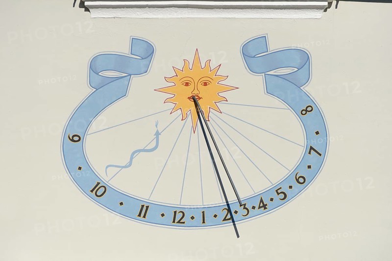 Sundial on house wall