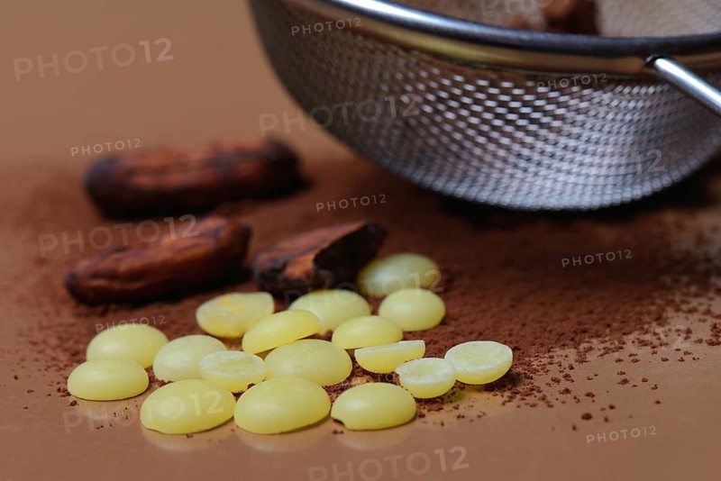 Cocoa powder in sieve and cocoa beans