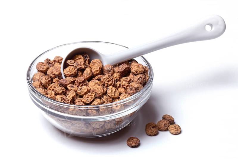Tigernuts with porcelain spoon in bowl