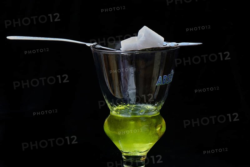 Glass of absinthe with absinthe spoon and sugar cubes