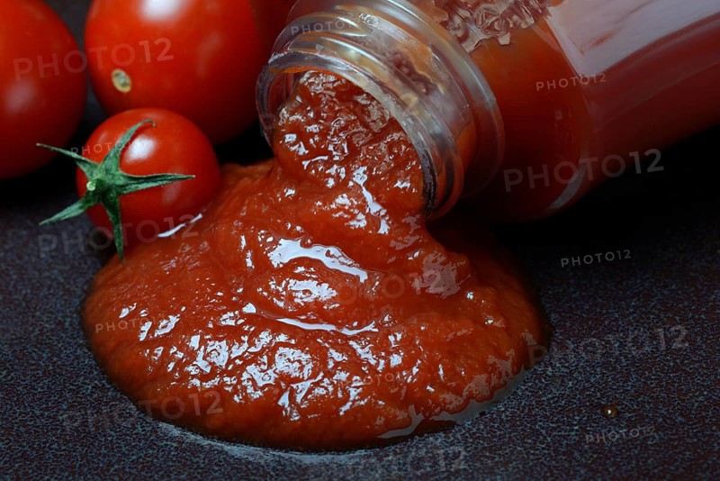Tomato ketchup flows from bottle