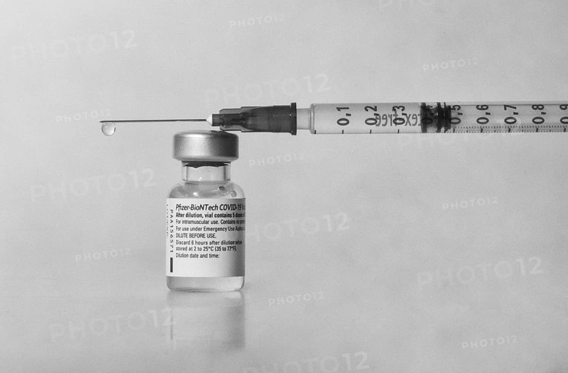 Vaccine vial against Covid 19 and syringe with drops