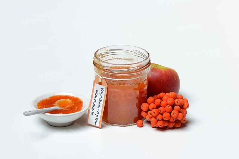Glass of rowanberry and apple jam with n