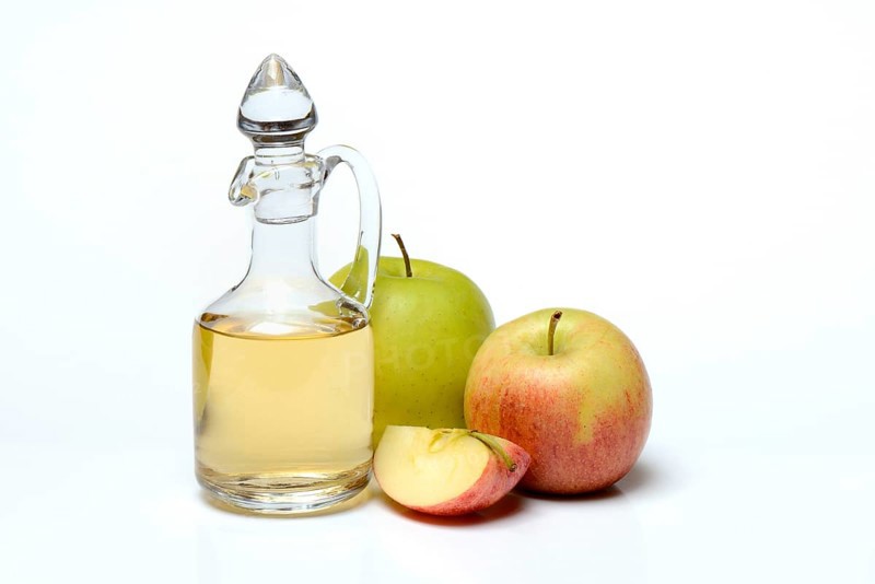 Carafe with apple vinegar and apples
