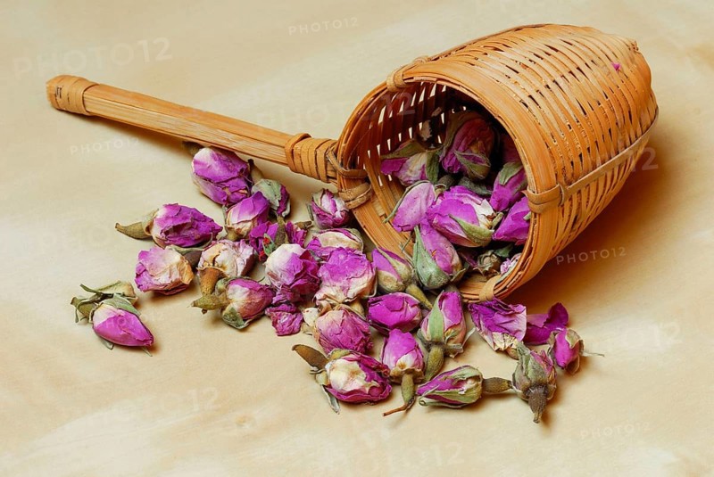 Dried rosebuds in bamboo tea strainer
