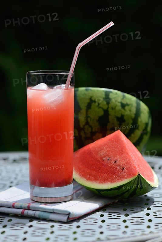 Watermelon juice in glass with drinking straw