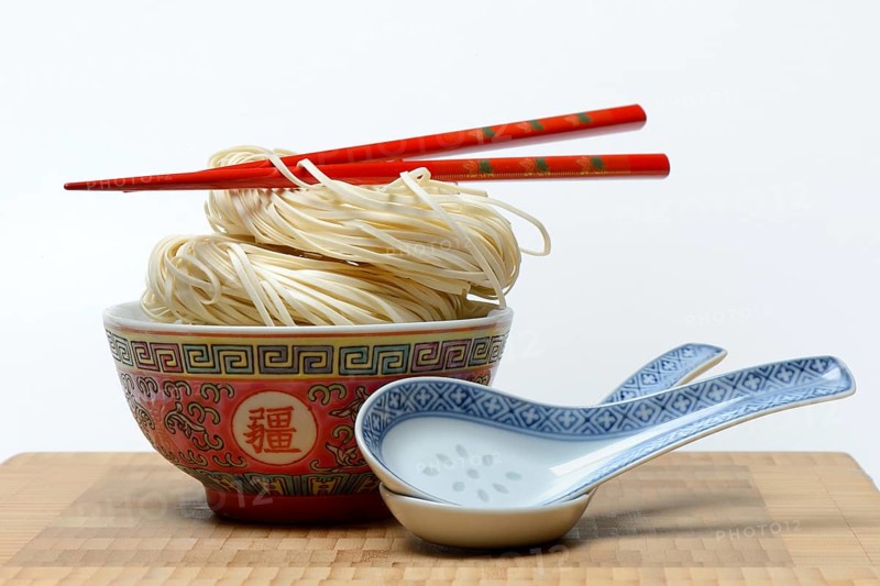 Chinese Yangchun noodles in bowl with chopsticks and porcelain spoon