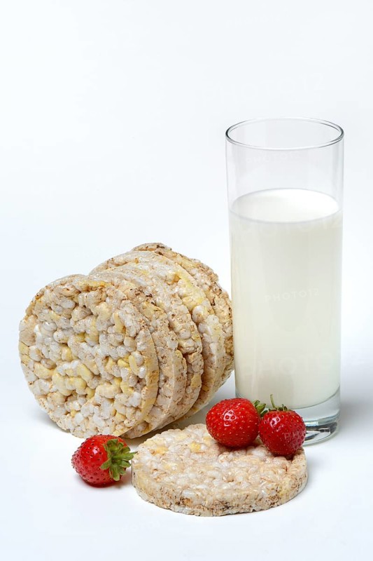 Corn and rice waffles with glass of milk and strawberries