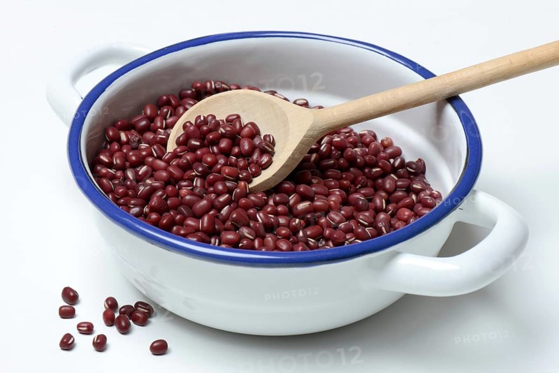 Dried azuki beans in bowl with wooden spoon