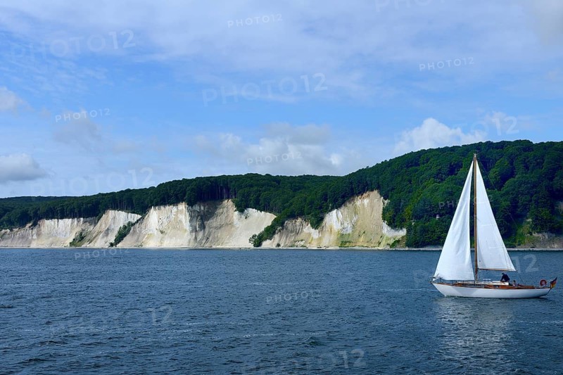 Chalk coast with sailing boat